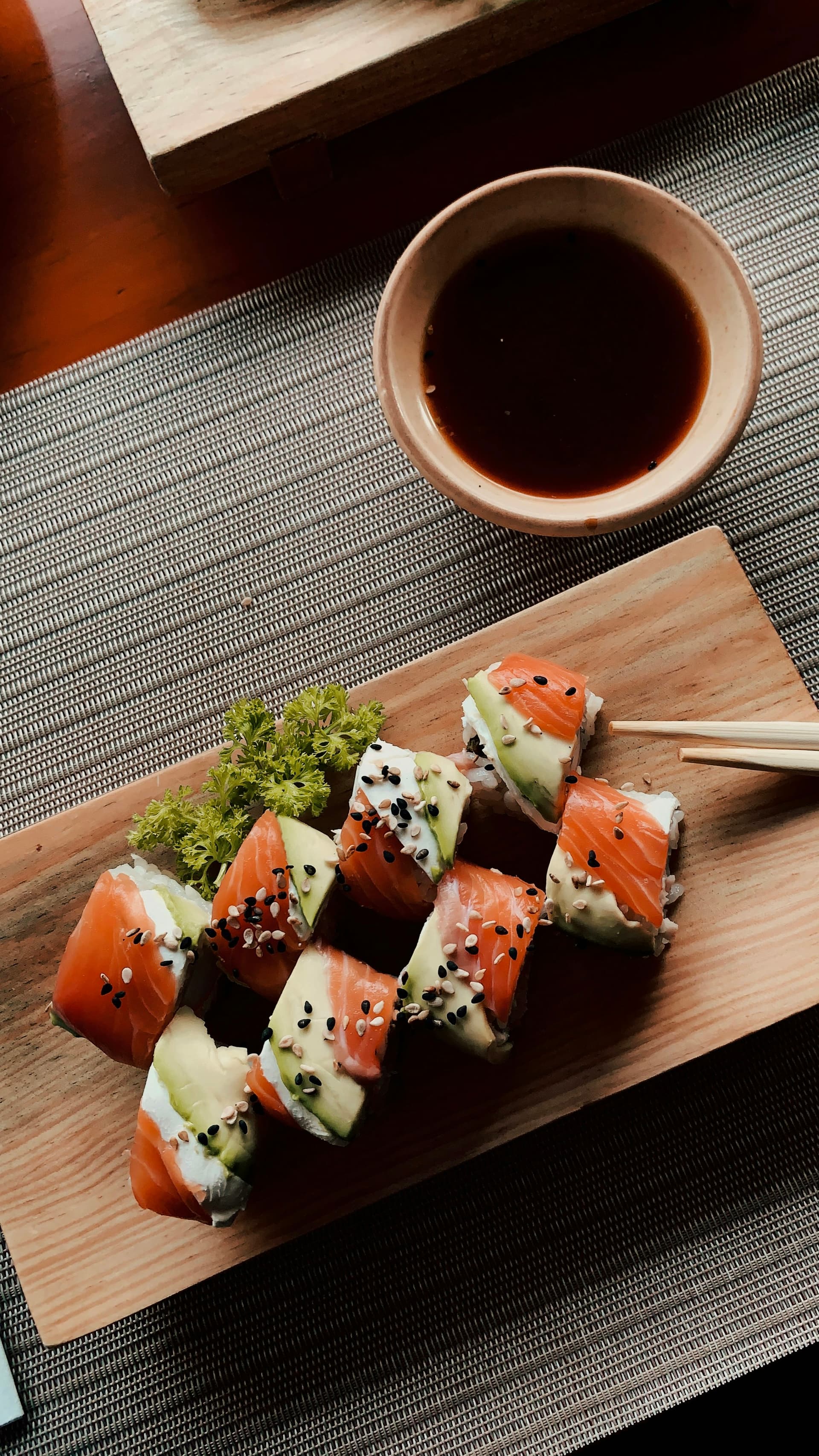 Assorted sushi and sashimi on a wooden board